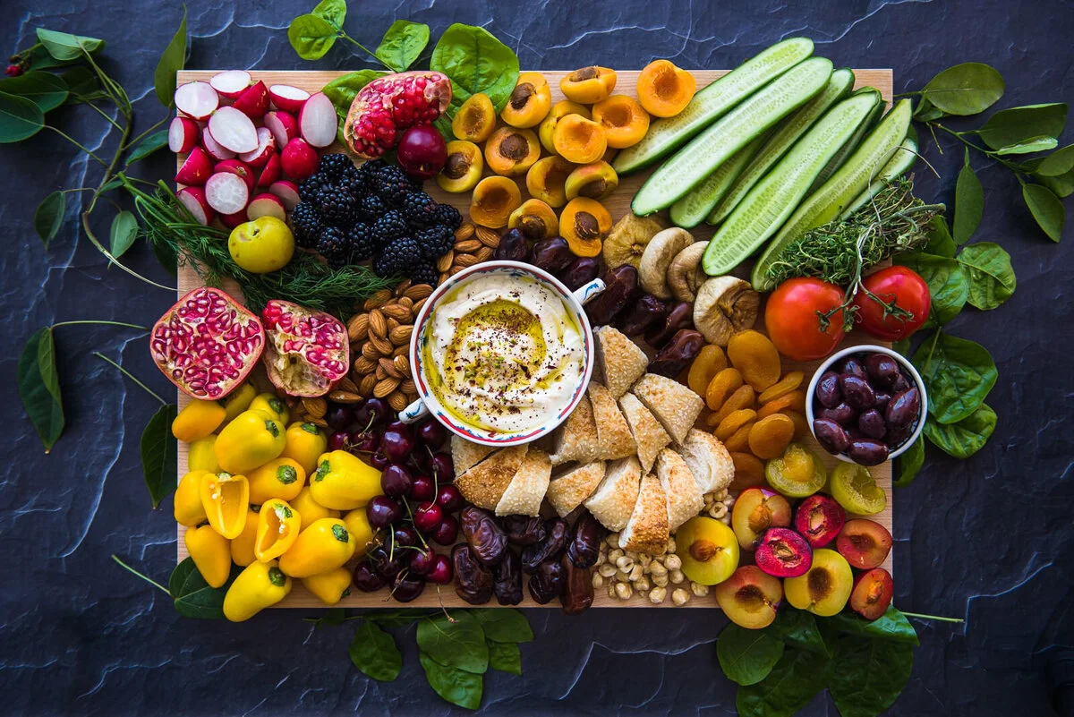 Arabic grazing board with labneh, vegetables, breads and pastries.