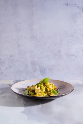 Animated food plating sequence against a pale backdrop.
