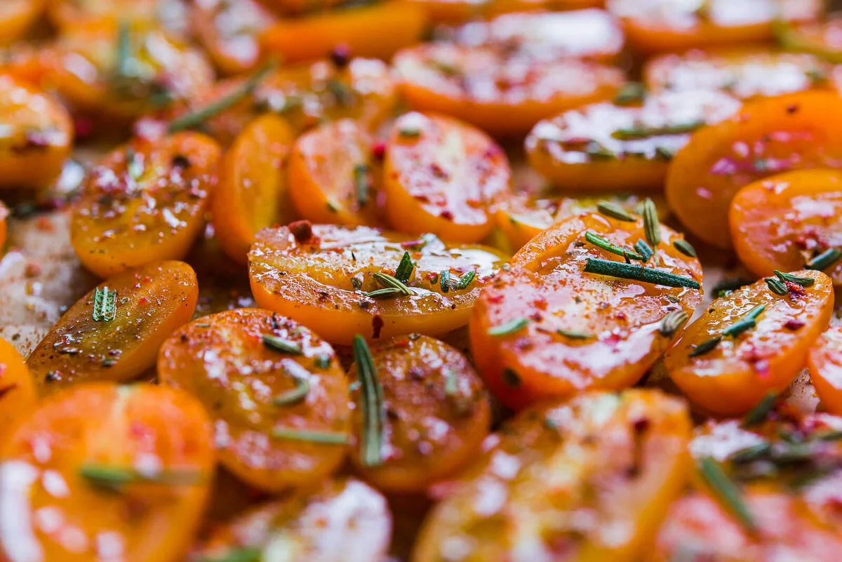 Tomato-topped canapés lined up on a serving tray.