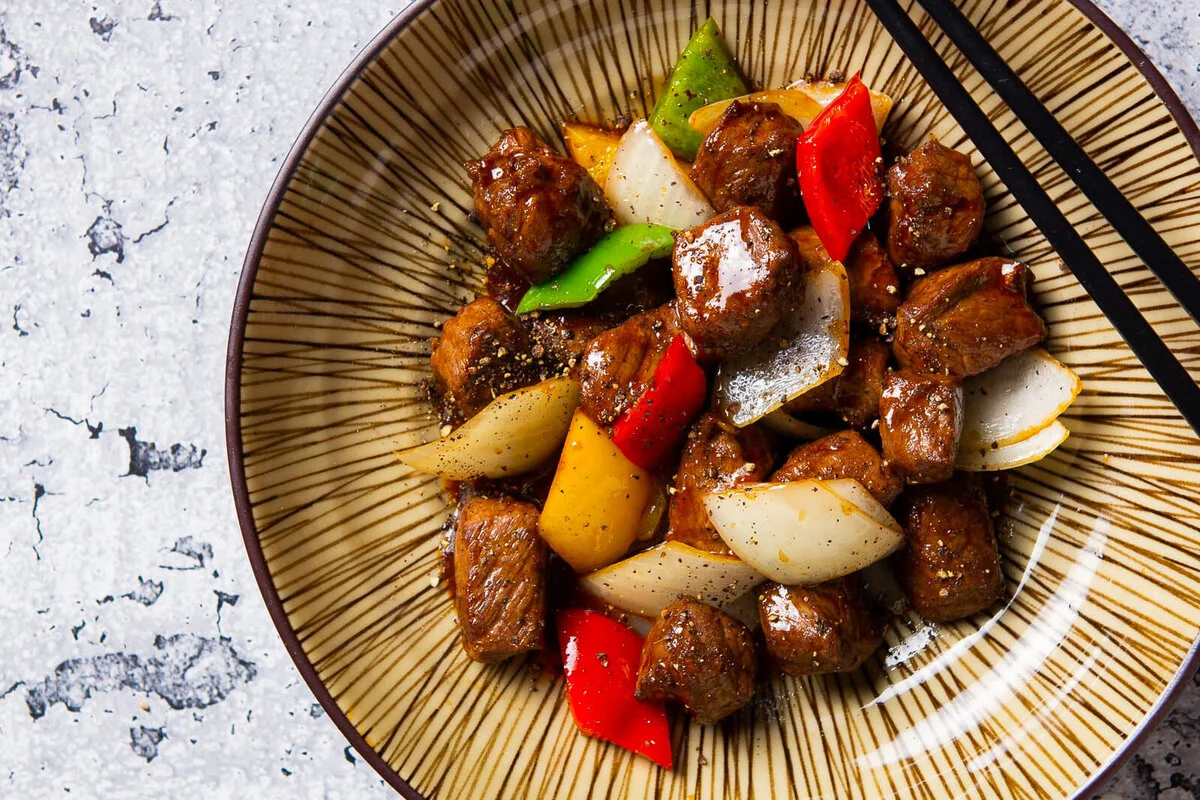 Beef tenderloin stir-fry with colorful peppers in black pepper sauce.